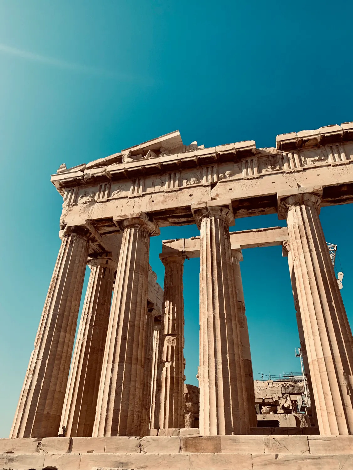 The sunlit columns of the Parthenon beneath a bright blue Athens sky