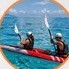 Travelers kayaking together on calm water